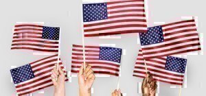 a group of hands holding small american flags