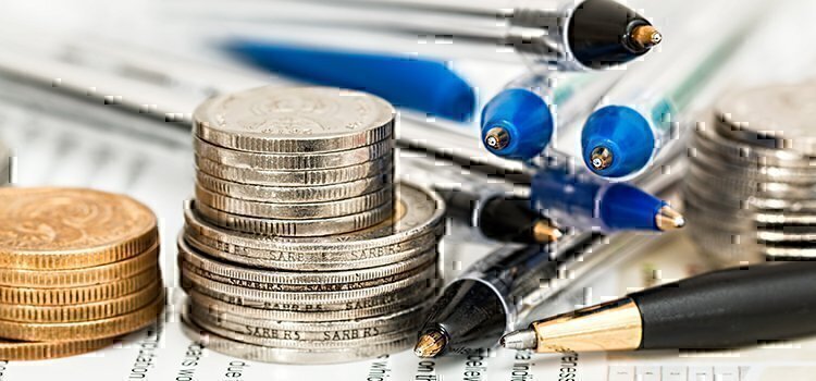a picture of coins and pens on a table