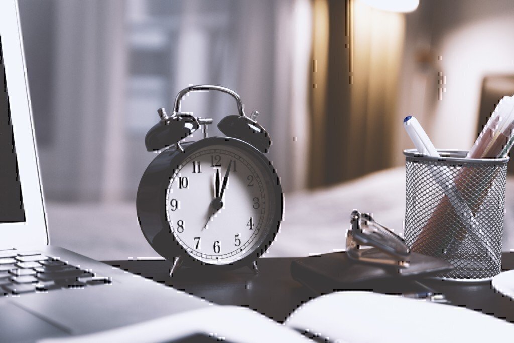 an alarm clock on an office desk