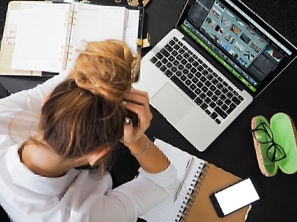 a lady working hard on a laptop