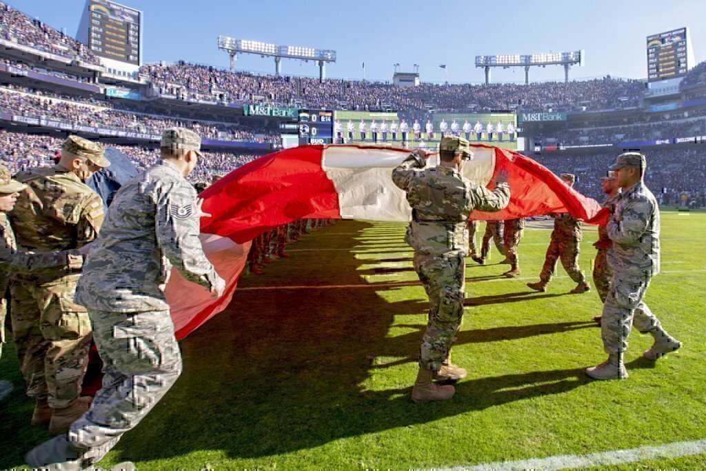 a group of soldiers holding a flag on a field