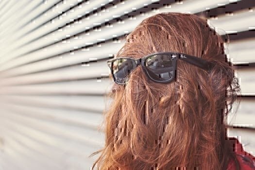 photo shows girl wearing sunglasses over her hair, which would be a mistake to do at a job interview