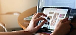 a picture of a man working on an ipad