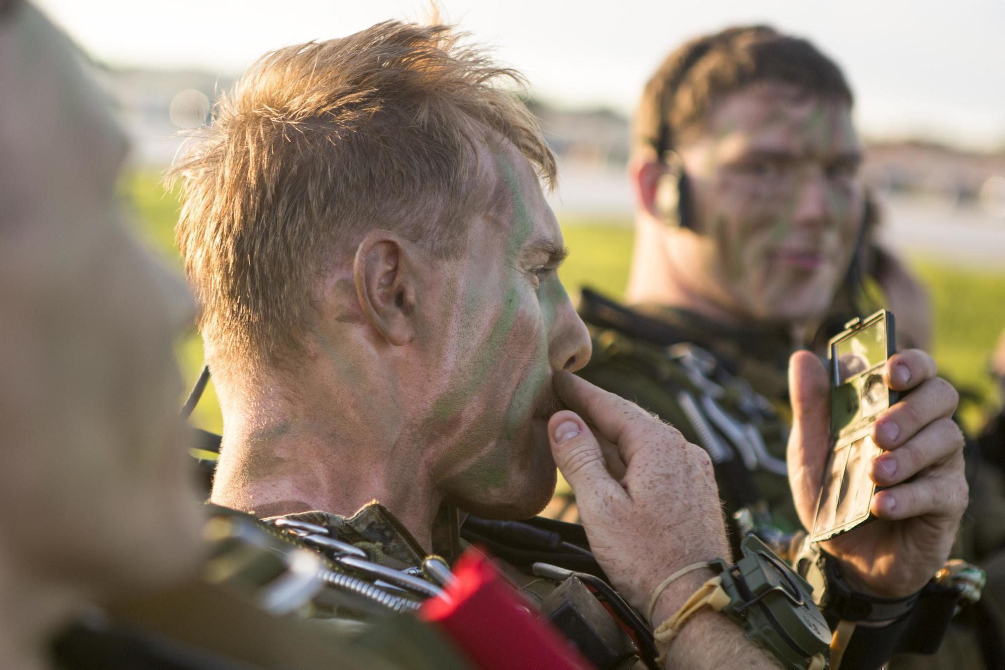 a man applying war paint on his face