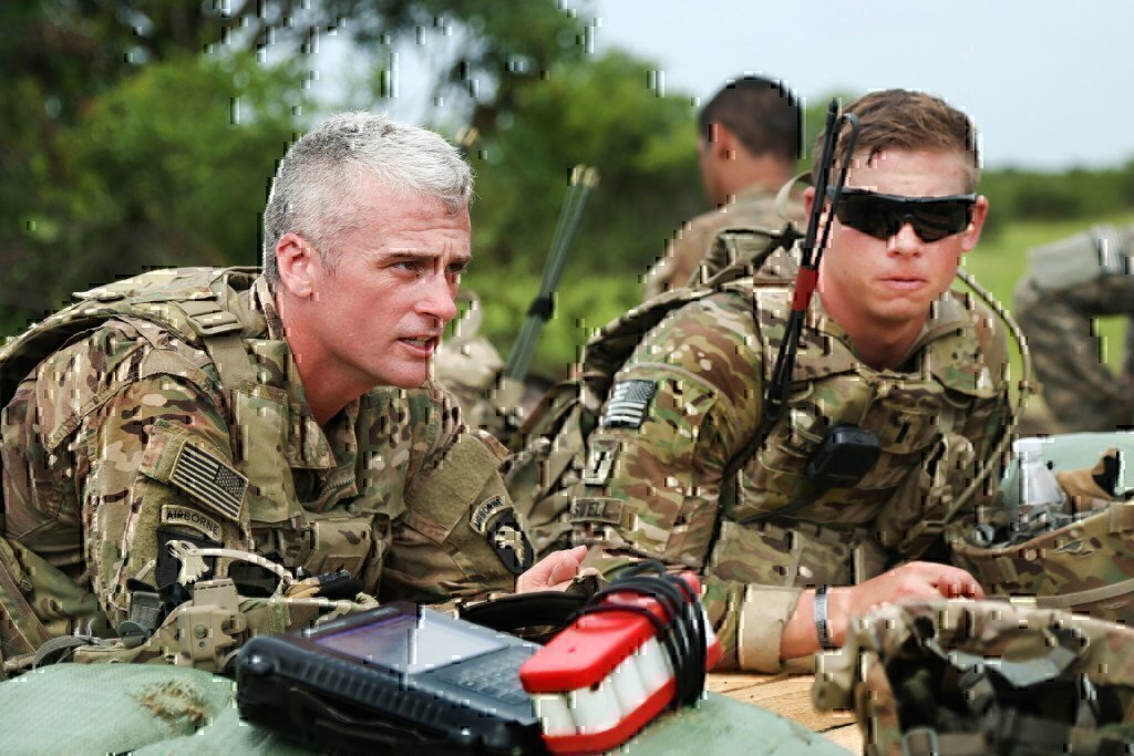 two soldiers working together on the ground