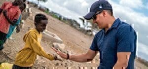 an army soldier talking with a kid