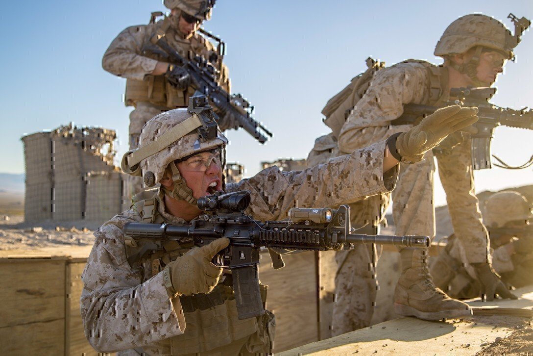 photo shows three soldiers engaging in a training exercise