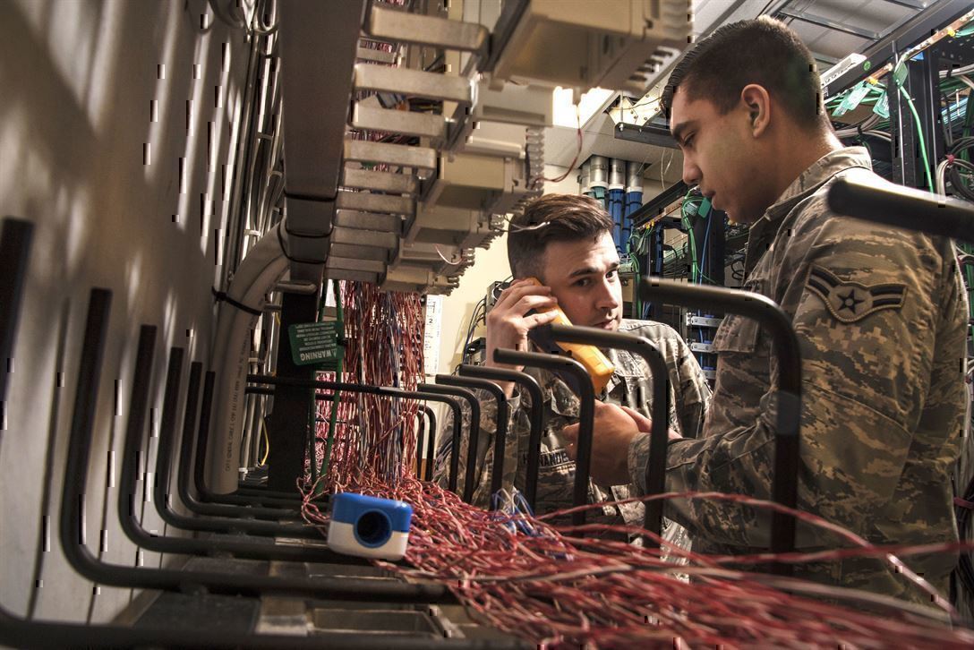 IT Jobs in the military give experience to service members like these air men, shown testing a system