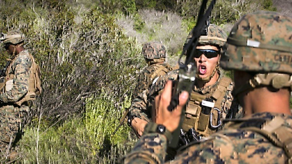 soldier yelling into a military phone