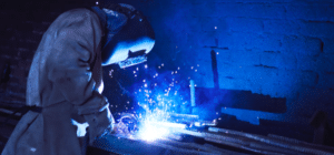 a welder welds a piece of metal