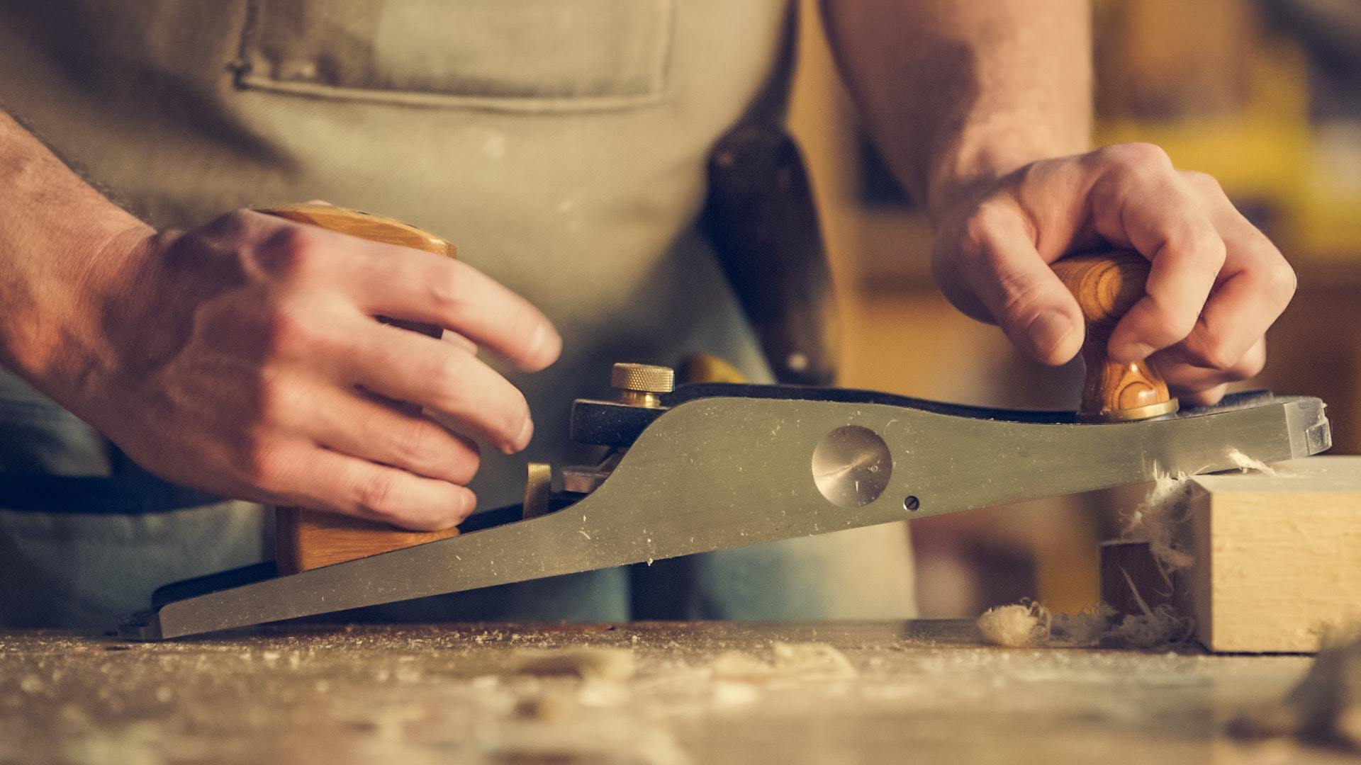 a carpenter works on a piece of wood