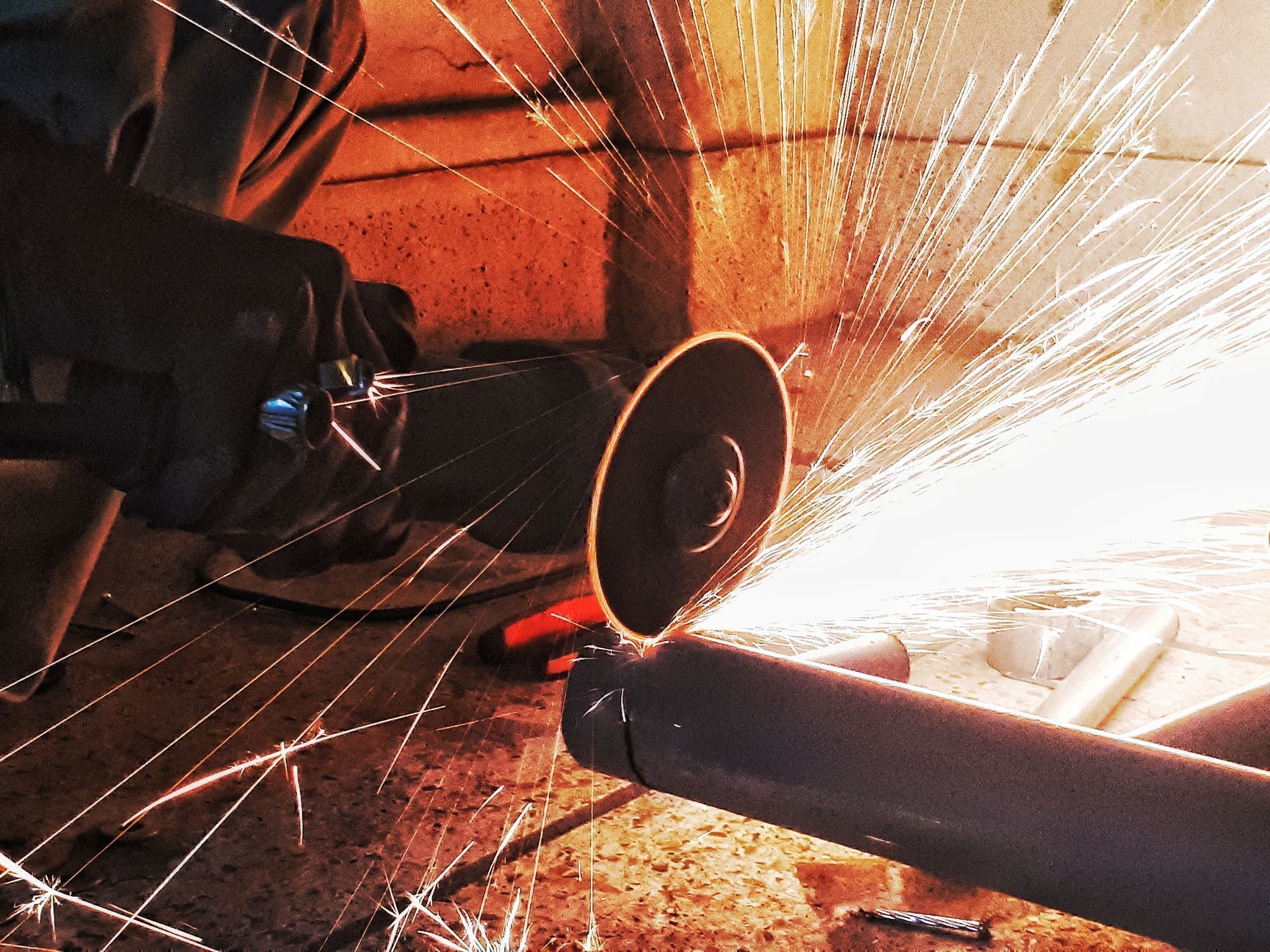 a person cuts metal with a saw