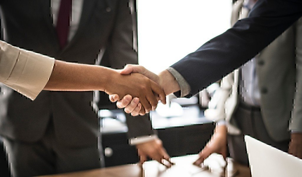 two business professionals shake hands