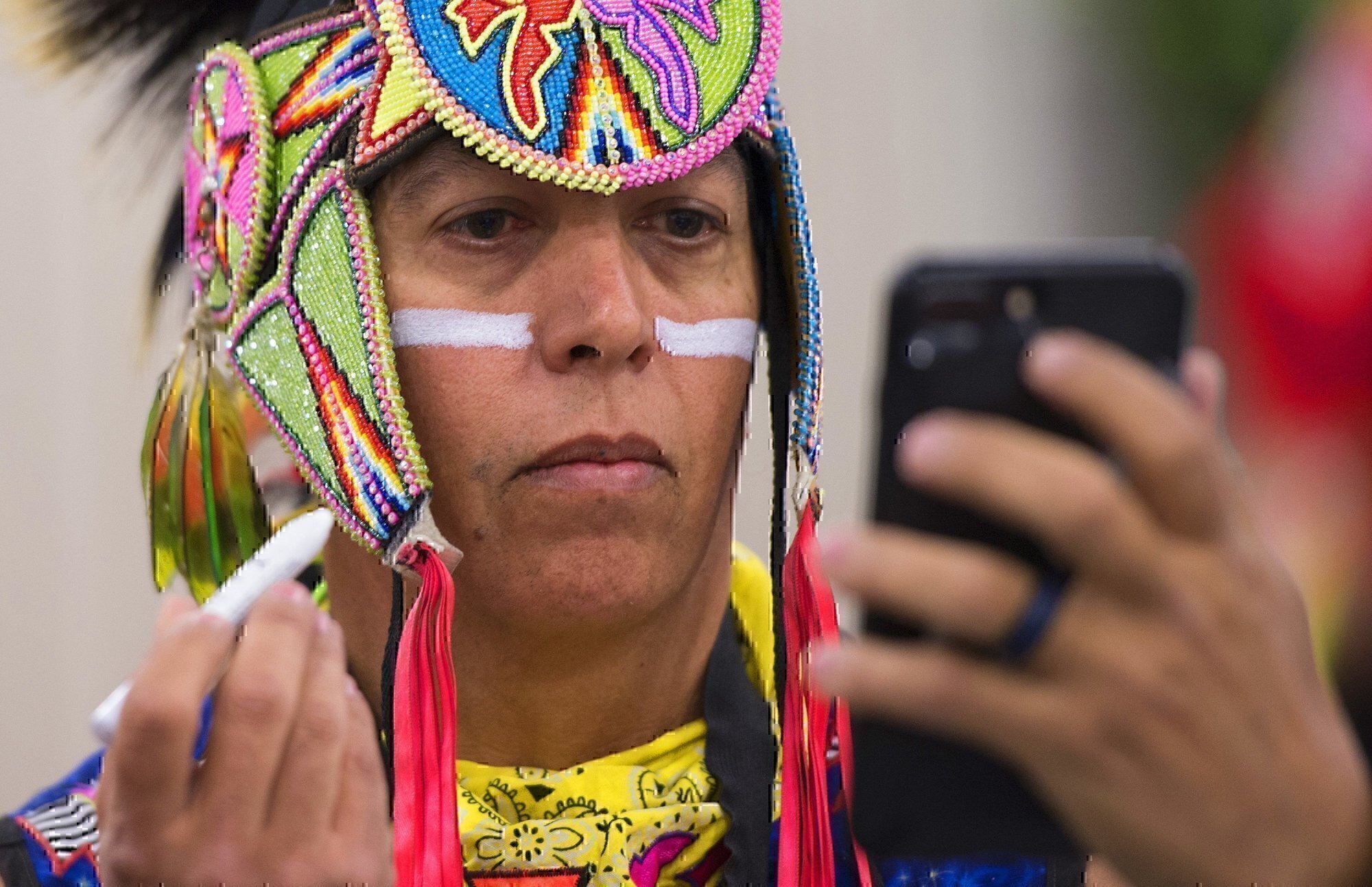 a soldier applies native american face paint