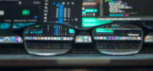 a pair of glasses is seen in front of a computer screen