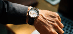 a person looks at their watch on their wrist
