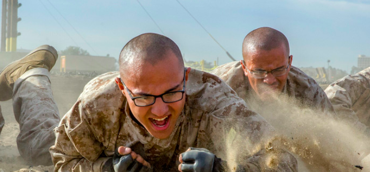 a group of marines crawl through sand