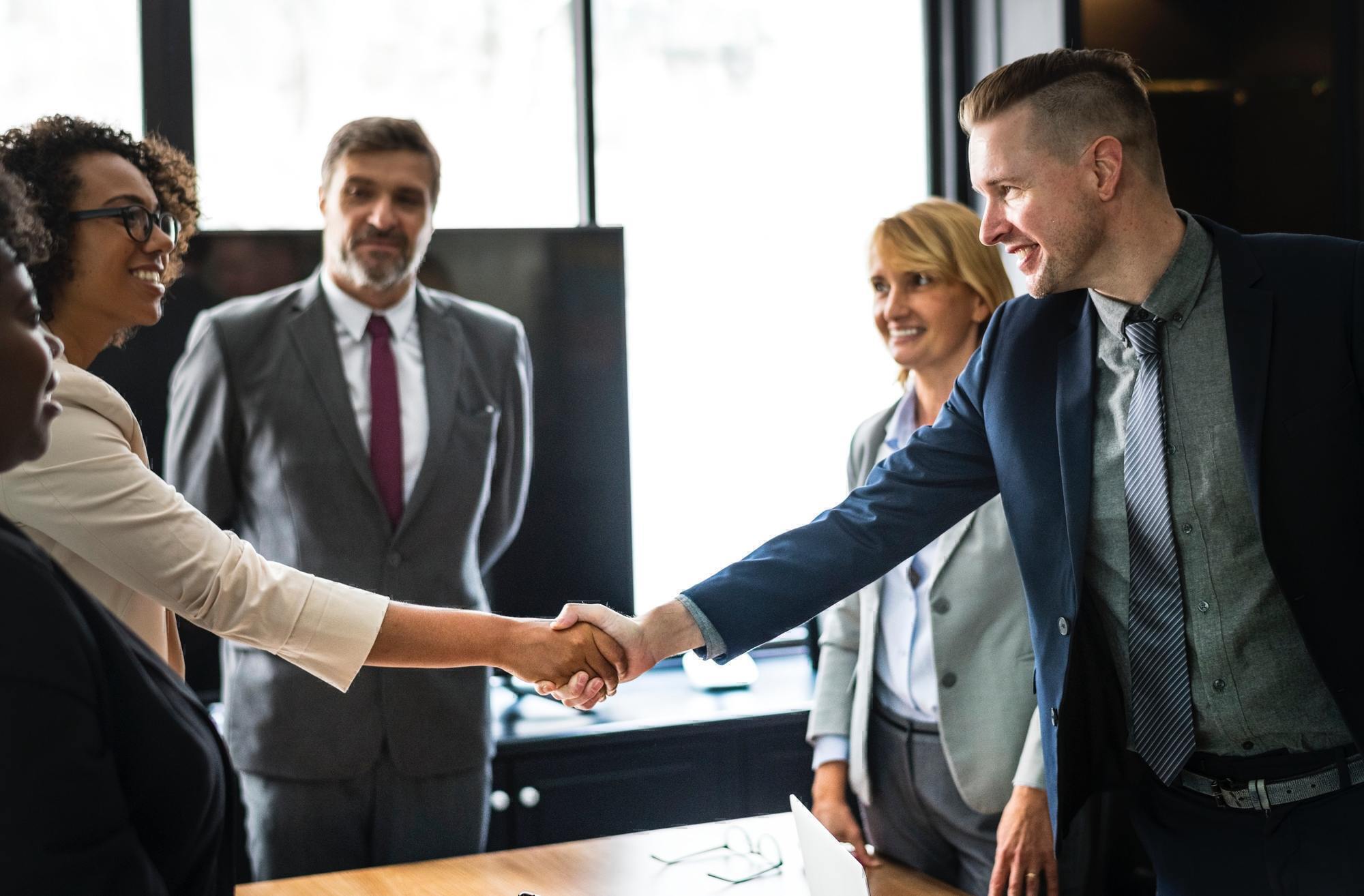 people shaking hands in a meeting