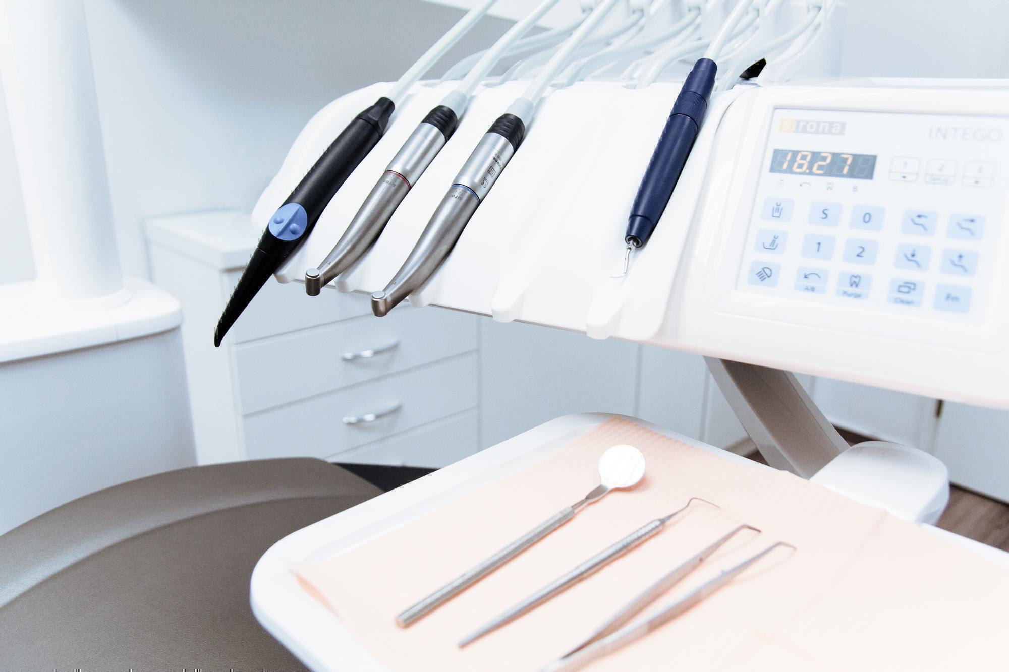 a set of dental tools sits in a dental office