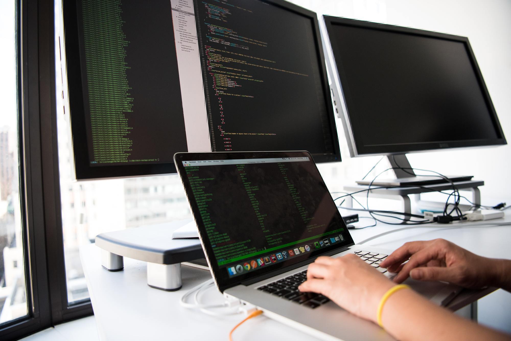 a person's hands are seen typing on a computer