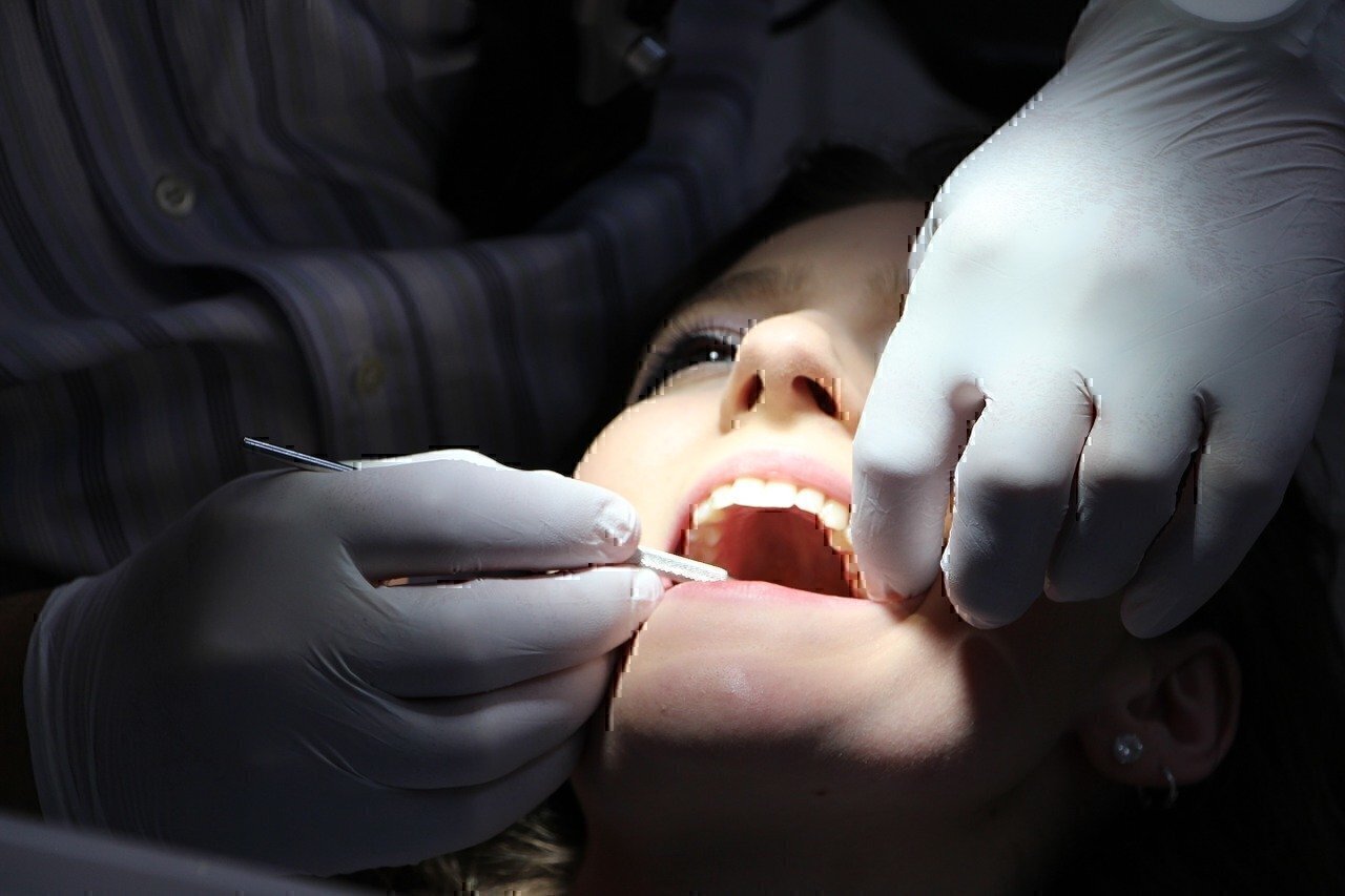 a dentist works on a patient's mouth