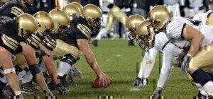 two football teams facing toward each other on the football field