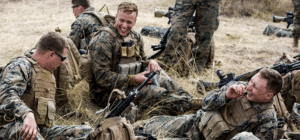 three soldiers in the field talking