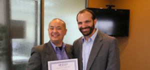 a student of the IT Ready program stands with his diploma