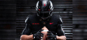 A football player models army's big red one uniform