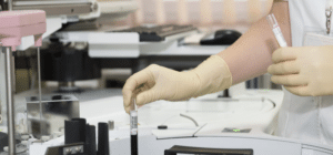 a lab technician handles a vile