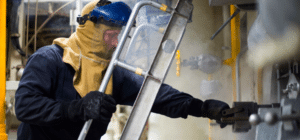 a u.s. sailor performs maintenance on a ship
