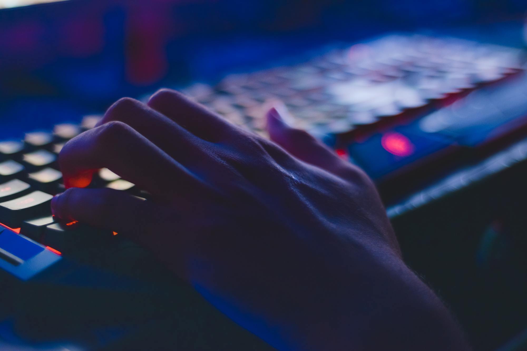 a person types on a computer keyboard