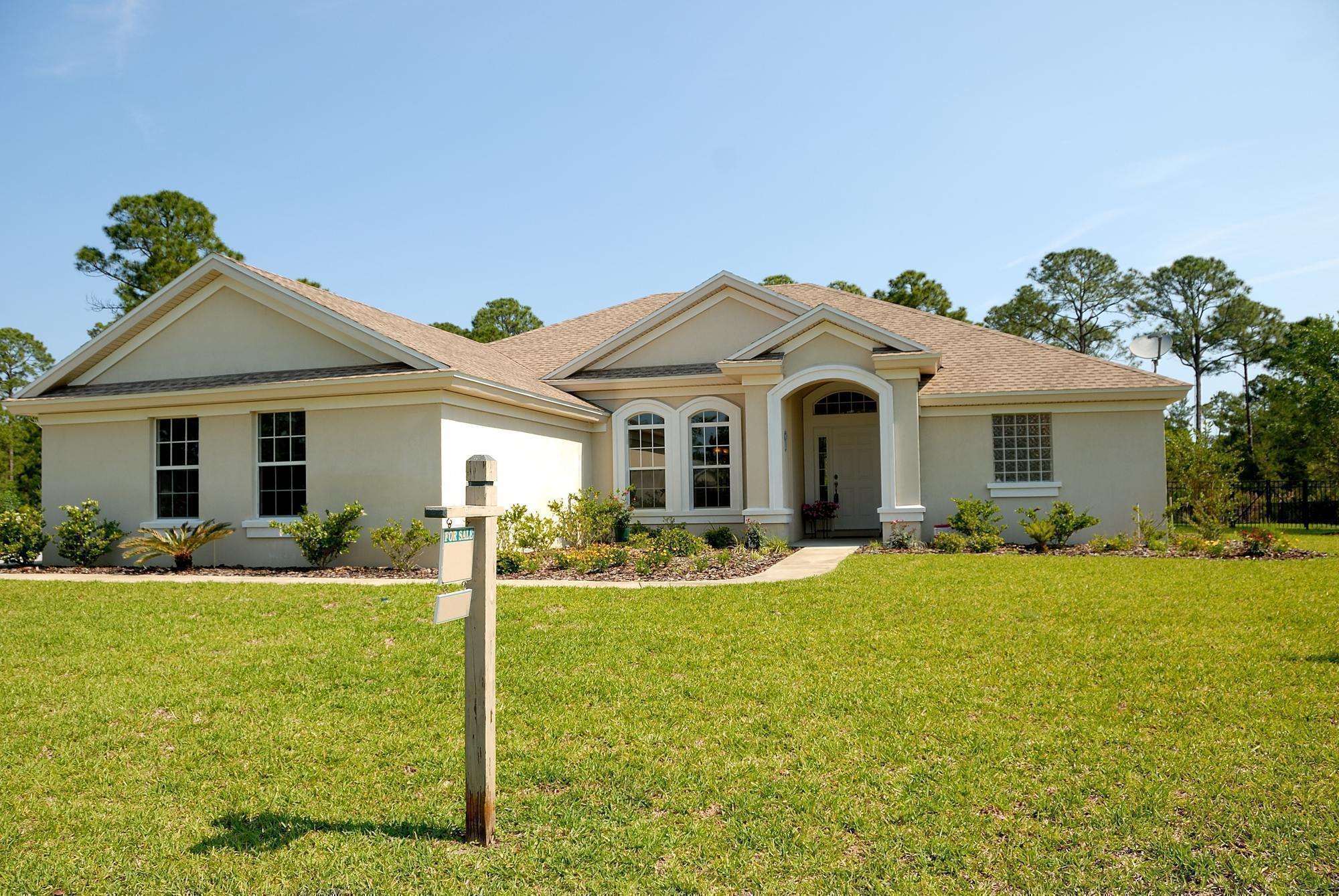 A home with a for sale sign in the yard