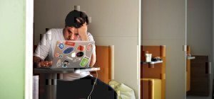 a man looking frustrated at his laptop