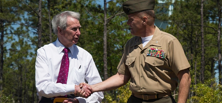 a marine meeting with a civilian shaking hands