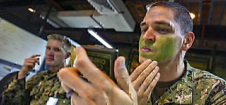 a man putting green face paint on