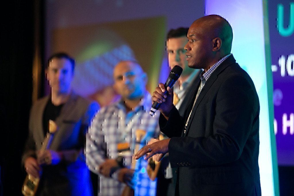 a picture of curtez riggs speaking at an event