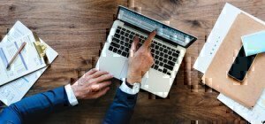 a man pointing on a laptop