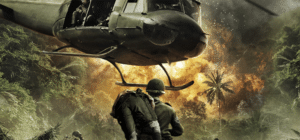 a picture of a soldier carrying another solider with a helicopter landing