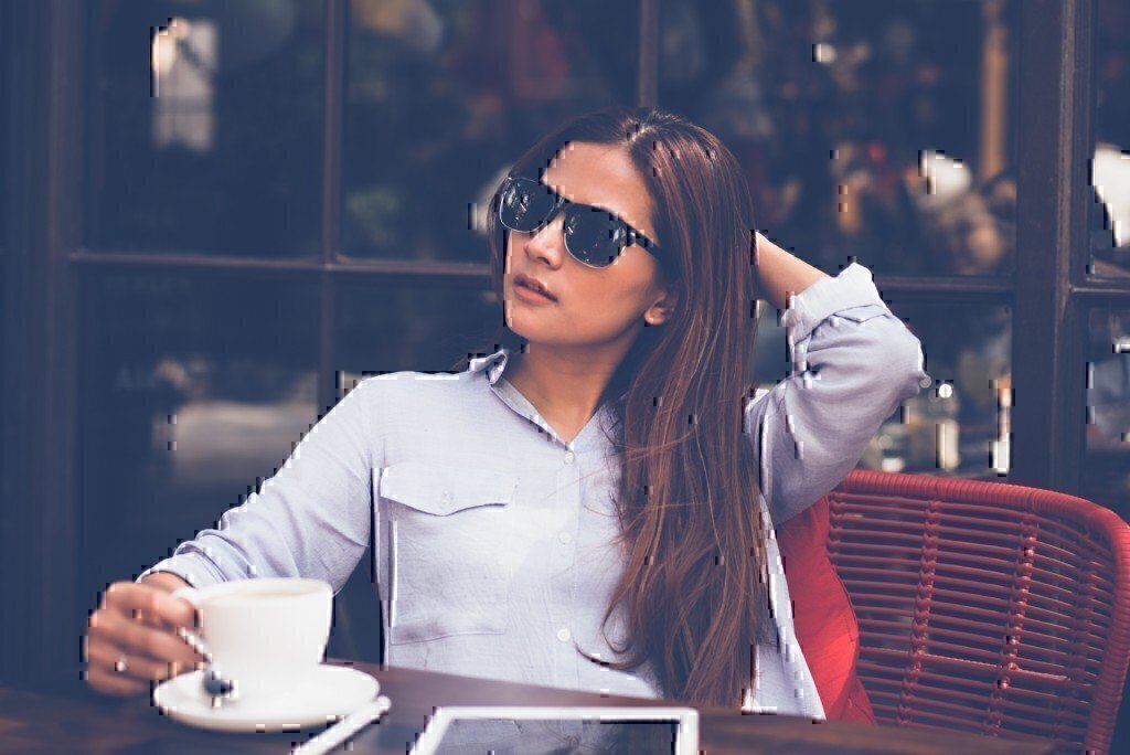 woman with sunglasses and a collared shirt on