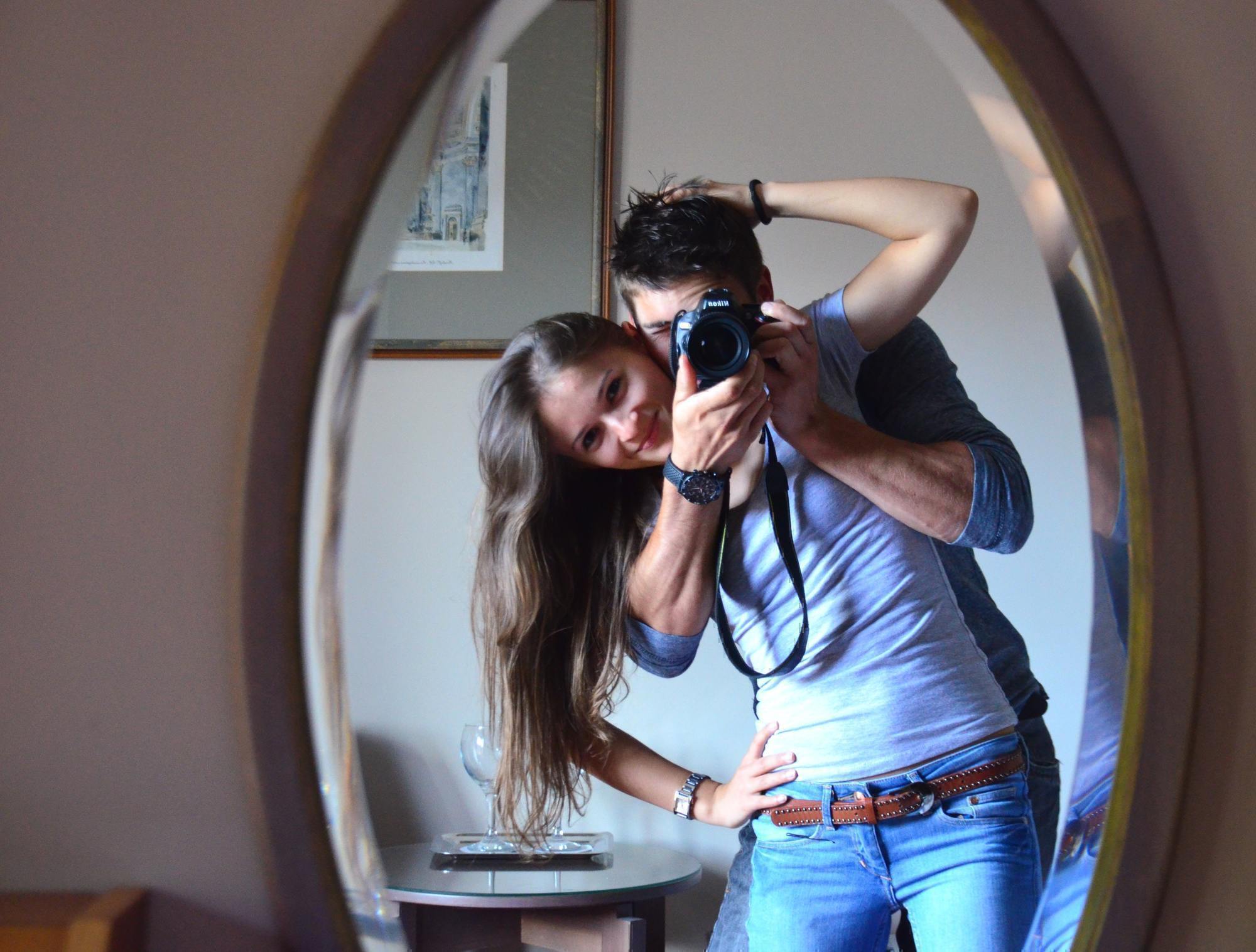 a picture of a couple in a mirror