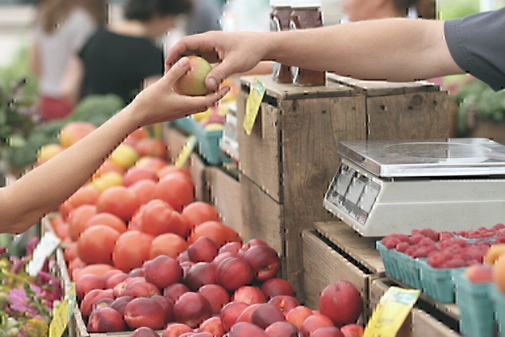 a man giving someone a fruit