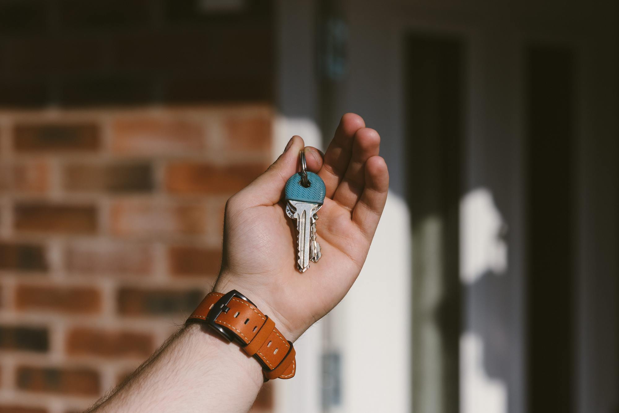 a picture of a man holding house keys