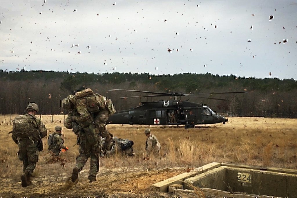 soldiers working together with a medical black hawk helicopter 