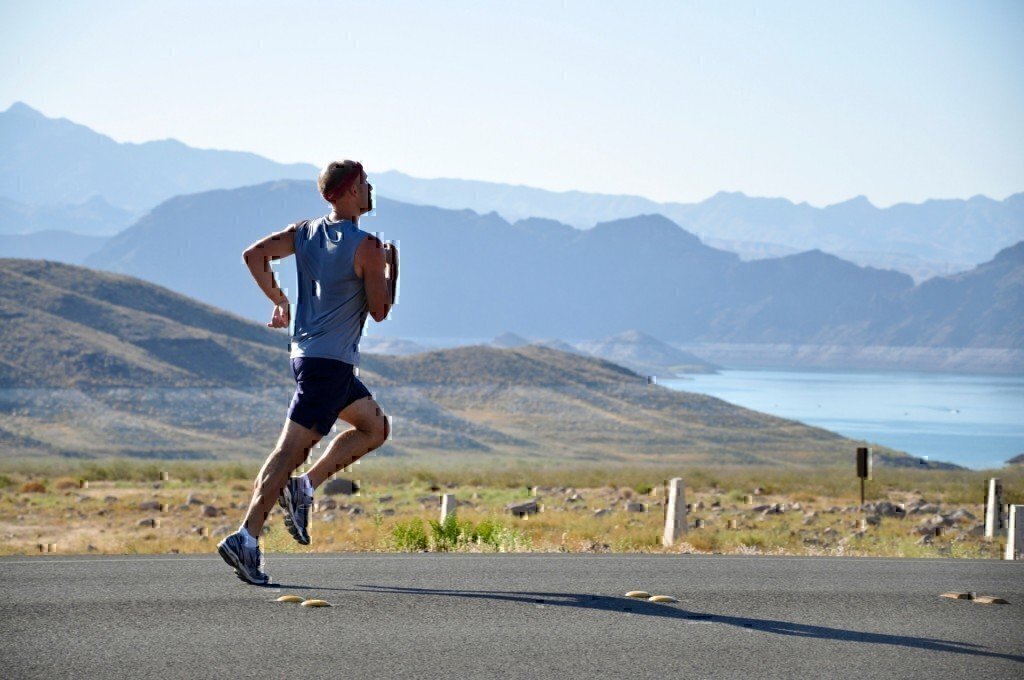 a picture of a man running in the mountains