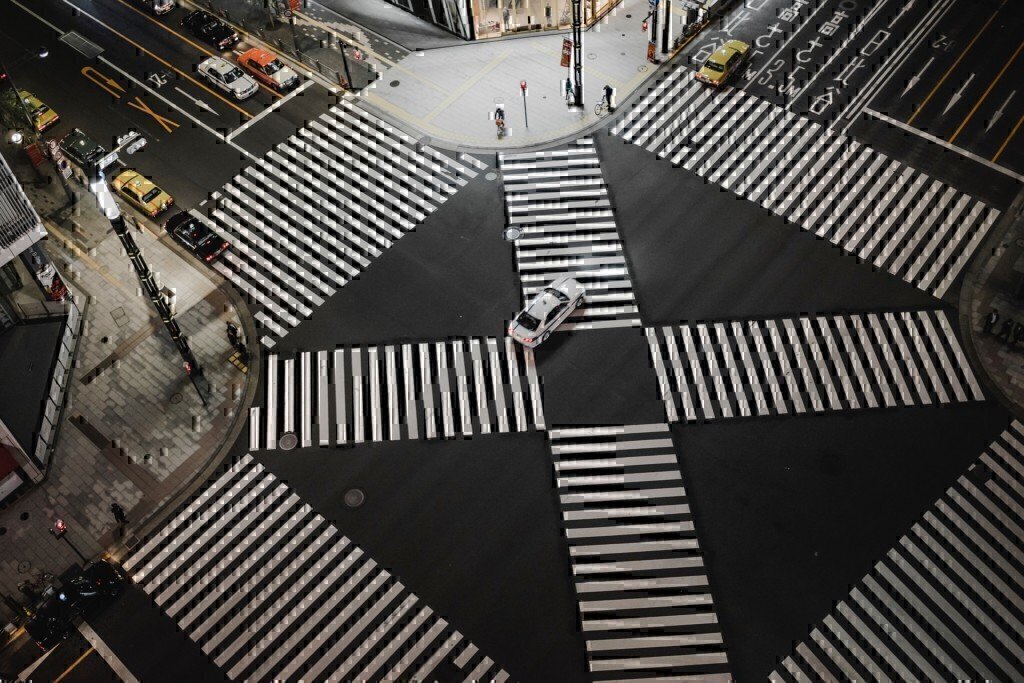 a car going through a crosswalk