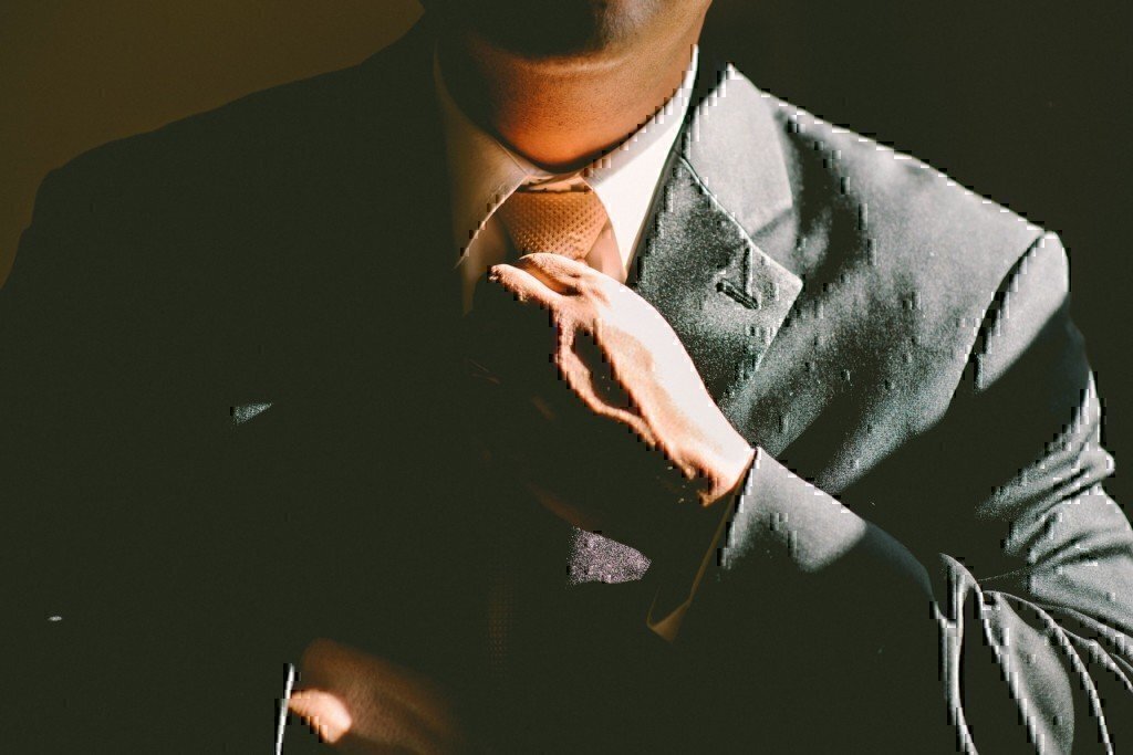 a man with a tie and suit