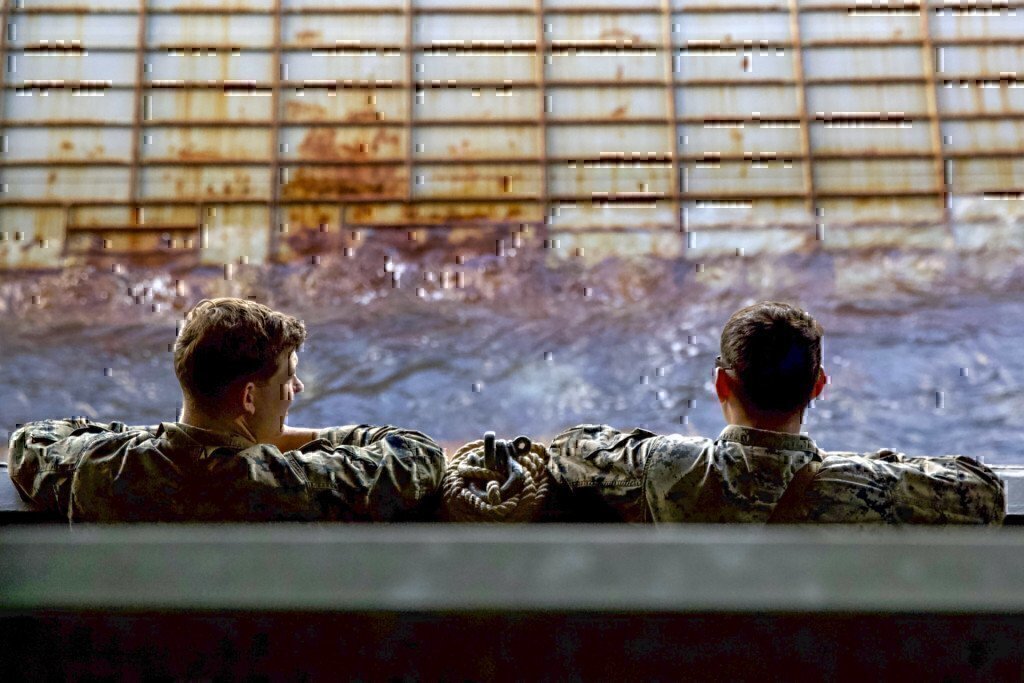 two marines working on a ship