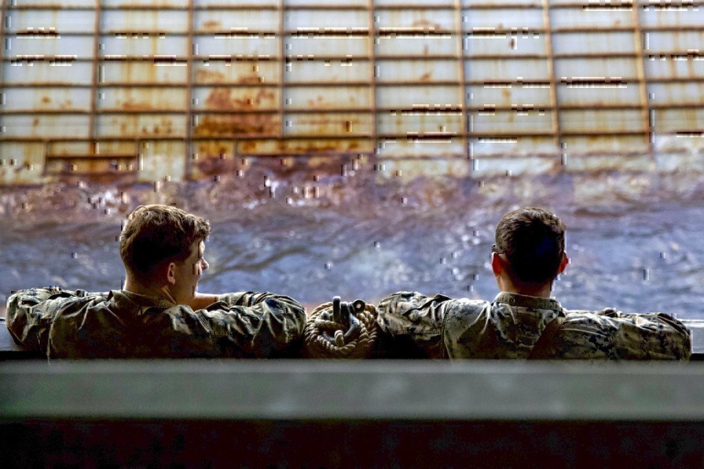 two marines working on a ship