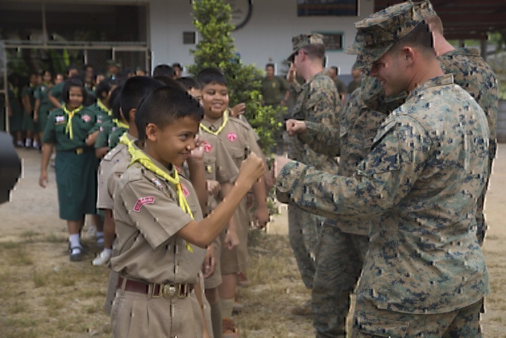 a solder fist bumping a kid